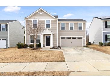 Charming two-story home with attached two car garage and inviting curb appeal at 1012 Old Evergreen Dr, Durham, NC 27704