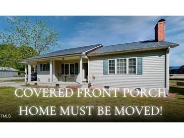 Charming single-story home featuring a welcoming covered front porch, complemented by green shutters and a well-maintained lawn at 107 N Pearl St, Princeton, NC 27569
