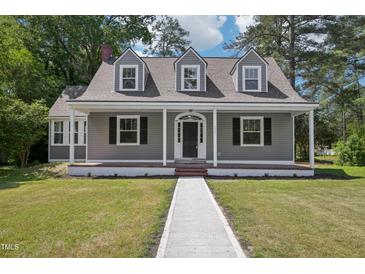 Charming home featuring gray siding, a welcoming front porch, and manicured green lawn with a concrete walkway at 1331 Sunset Ave, Rocky Mount, NC 27804