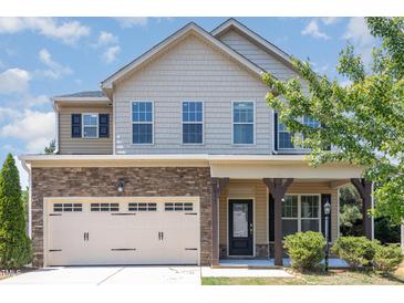 Charming two-story home with stone accents, covered porch and two car garage at 163 Davelyn Ct, Garner, NC 27529