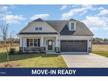 Charming two-story home featuring a gray garage door and a well-manicured front lawn at 175 Trescott St, Smithfield, NC 27577