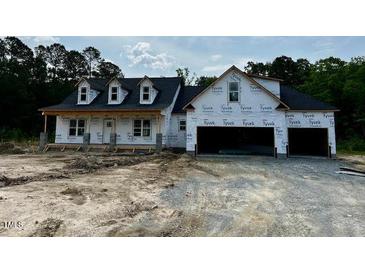 Exterior of a new home build with two-car garage and black roof at 196 Cozy Brook Ct, Clayton, NC 27520