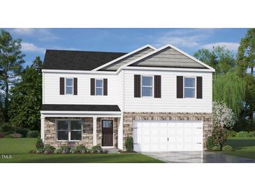 Charming two-story home featuring stone accents, attached two-car garage, and meticulously manicured landscaping at 196 Ethel Ln, Angier, NC 27501