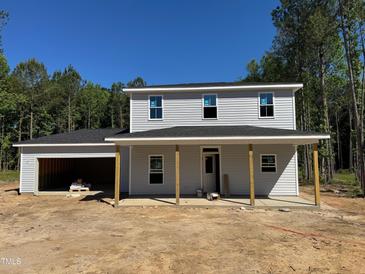 Charming two-story home featuring a welcoming front porch and attached two-car garage at 337 Green Pines Estates Dr, Kenly, NC 27542