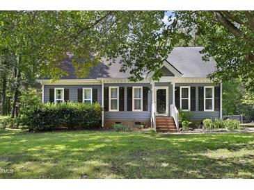 Charming home featuring mature landscaping, a well-manicured lawn, and a welcoming entrance at 413 Redpath Dr, Garner, NC 27529