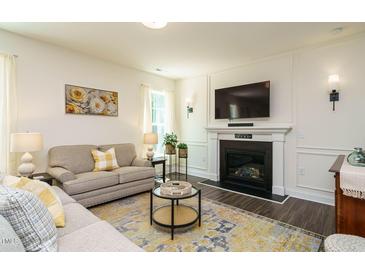 Inviting living room with a cozy fireplace, comfortable seating, and stylish decor at 555 Whitley Ridge Dr, Clayton, NC 27527