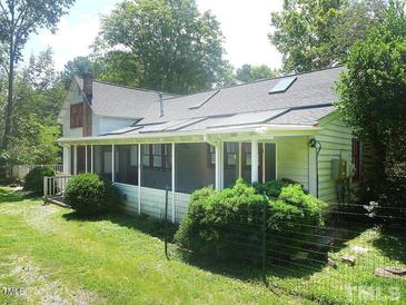 Charming home with a screened porch, a fenced yard, and mature trees, creating a peaceful retreat at 915 Phils Creek Rd, Chapel Hill, NC 27516