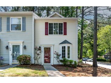 Charming townhome with white siding, red shutters, and well-manicured landscaping at 102 Rosebrooks Dr, Cary, NC 27513