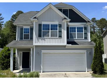 Charming two-story home featuring an attached two-car garage and well-maintained landscaping at 105 Blue Bay Ln, Cameron, NC 28326