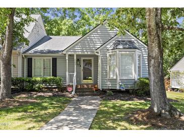 Charming home featuring a bay window, landscaped yard and welcoming front porch at 140 Heatherwood Dr, Apex, NC 27502