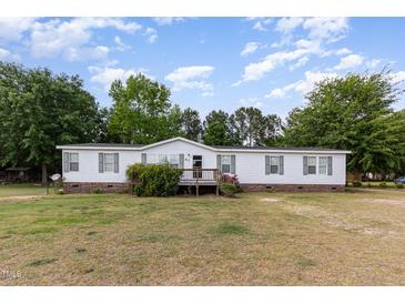 Charming single-story home with a well-maintained lawn and a cozy front porch at 168 Hoss Ridge Ln, Dunn, NC 28334