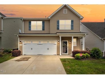 Charming two-story home with a well-manicured lawn and a two-car garage, perfect for families at 1839 Huntley Way, Burlington, NC 27215