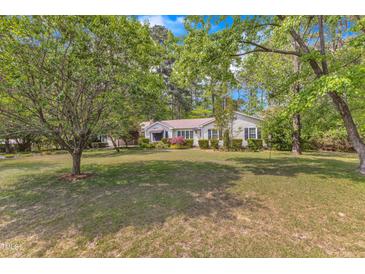 Charming one-story home with mature trees and a well-manicured lawn at 2608 Knightwood Rd, Fuquay Varina, NC 27526