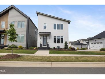 Modern two-story home with white siding, sleek lines, neat landscaping, and a covered front entrance at 270 Wendover Pkwy, Pittsboro, NC 27312