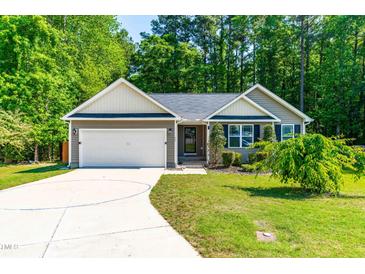 Charming single-story home with a two-car garage and landscaped front yard at 33 Carrington Cir, Angier, NC 27501