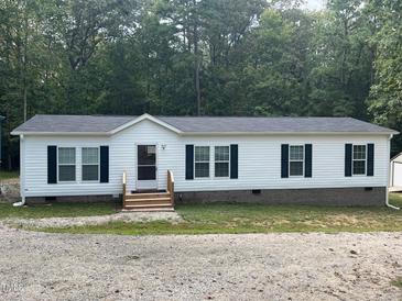 Charming single-story home with white siding, black shutters, and a new roof surrounded by mature trees at 420 Spring Ln, Henderson, NC 27537