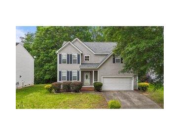 Charming two-story home featuring gray siding, a manicured lawn, and an attached two-car garage at 468 Hay River St, Garner, NC 27529