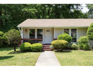 Charming home showcasing a well-manicured lawn, mature trees, and a welcoming front porch at 103 Westview Dr # Apt K, Carrboro, NC 27510