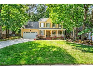 Charming two-story home with a well-manicured lawn, attached garage, and inviting front porch at 11 Bridgeport Dr, Durham, NC 27713