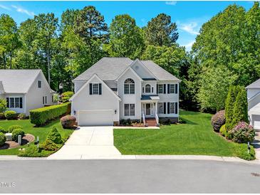 Charming two-story home with lush landscaping and a well-manicured lawn at 11 Smoketree Ct, Durham, NC 27712