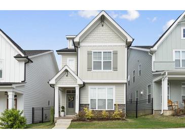 Charming two-story home with neutral siding, a welcoming porch, and well-manicured landscaping at 1641 Glazebrook Dr, Wake Forest, NC 27587