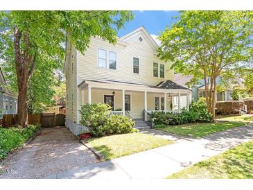 Charming two-story home with a lovely front porch and mature trees providing shade at 216 N Bloodworth St, Raleigh, NC 27601