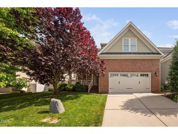 Charming brick home with a well-manicured lawn and a two-car garage at 2728 Cameron Pond Dr, Cary, NC 27519