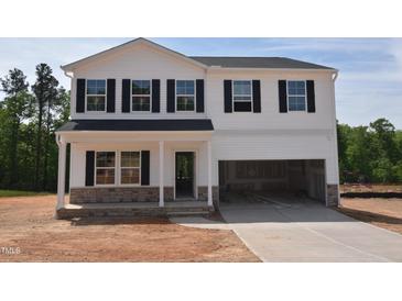 Charming two-story home featuring white siding, black shutters, and an attached two-car garage at 85 Cordoba Dr, Franklinton, NC 27525