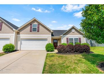 Charming home with a manicured lawn and a two-car garage under a bright blue sky at 1004 Gold Cir, Mebane, NC 27302