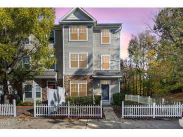 Charming two-story townhome with a white picket fence and well-maintained landscaping at 11700 Coppergate Dr # 100, Raleigh, NC 27614