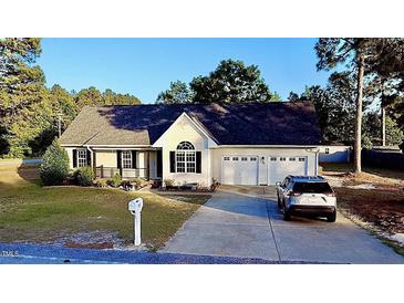 Charming single-Gathering home with a well-maintained lawn, two-car garage, and covered porch at 15 Colonial Hills Dr, Lillington, NC 27546