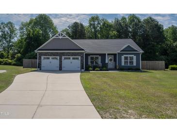 Charming single-story home featuring a two-car garage, landscaped front yard, and inviting entrance at 199 Courtney Ln, Dunn, NC 28334