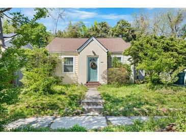 Charming bungalow featuring a quaint front entrance, complemented by lush green surroundings at 214 Northwood Cir, Durham, NC 27701