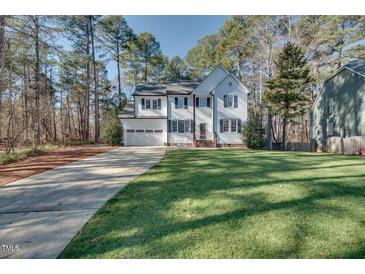 Charming two-story home with a well-manicured lawn and attached two car garage at 215 Graduate Ct, Durham, NC 27713