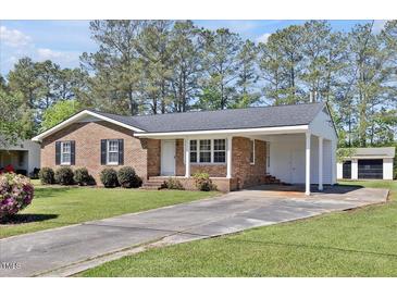 Well-maintained home offers brick facade, established landscaping, and attached carport on a large lot at 2624 Gary Rd, Rocky Mount, NC 27803