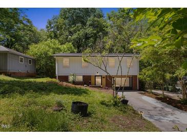 Two-story home with green lawn, red brick base, and an asphalt driveway at 2904 Sprucewood Dr, Durham, NC 27707