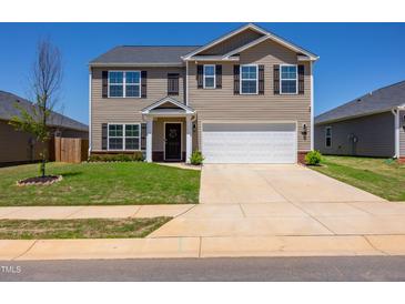 Charming two-story home featuring a well-manicured lawn, a two-car garage, and classic curb appeal at 2923 Cullens Dr, Graham, NC 27253