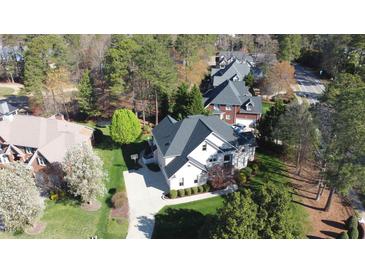 Aerial shot of a two-story home with a driveway and well-maintained landscaping at 325 Hogans Valley Way, Cary, NC 27513