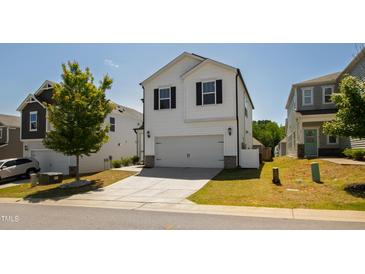 Charming two-story home with a two-car garage and a well-manicured lawn at 33 White Ash Dr, Clayton, NC 27527