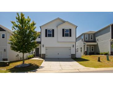 Charming two-story home with a manicured lawn, two-car garage, and a bright, modern exterior at 33 White Ash Dr, Clayton, NC 27527