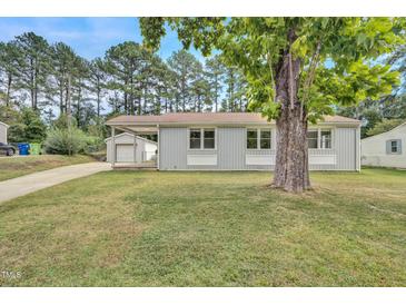 Charming home featuring a well-maintained front yard and a convenient carport at 3312 Apache Dr, Raleigh, NC 27609