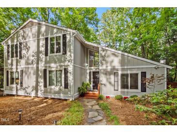 Two-story home with a modern design and lush landscaping in a serene wooded setting at 568 Piney Mountain Rd, Chapel Hill, NC 27514