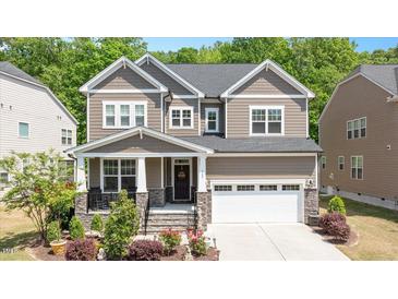 Charming two-story home with a landscaped front yard and inviting front porch, plus a two car garage at 745 Orange Oak Ln, Apex, NC 27523