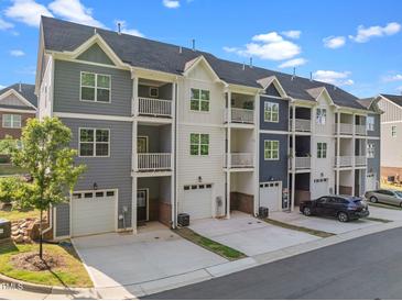 Modern townhome exteriors featuring individual garages and private balconies; a blend of comfort and style at 820 Laurel Gate Dr, Wake Forest, NC 27587