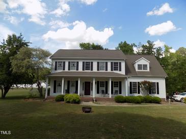 Charming two-story home features a welcoming front porch and well-manicured lawn at 101 Cardinal Dr, Youngsville, NC 27596
