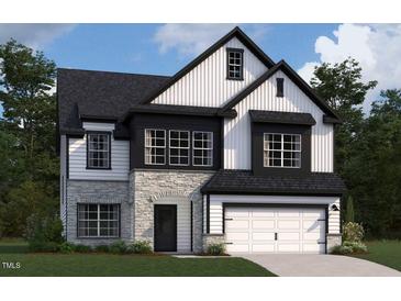 Charming two-story home with stone accents, white siding, and a neatly manicured lawn at 109 Moonflower Ln # Homesite 260, Wilson's Mills, NC 27520