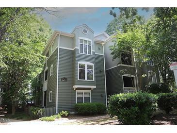 Charming condo with neutral colors and lovely surrounding landscaping with green trees at 1211 Westview Ln # 201, Raleigh, NC 27605