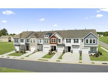 Charming townhomes featuring covered entries and attached one car garages at 20 Hyacinth Ln # 100, Angier, NC 27501