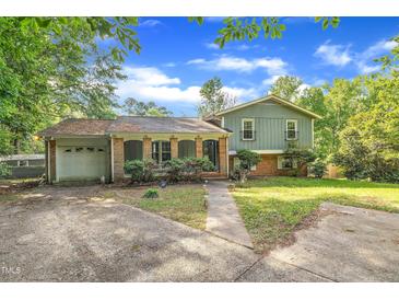 Charming two-story home featuring a brick facade, front porch, and attached garage at 2608 Foxgate Dr, Raleigh, NC 27610