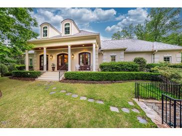 Charming exterior with a large front porch, white columns, and beautiful landscaping at 403 Granville Rd, Chapel Hill, NC 27514